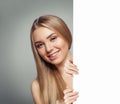 Smiling model woman with clear skin holding empty white card singboard Royalty Free Stock Photo