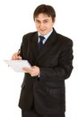 Smiling modern businessman making notes in notepad Royalty Free Stock Photo