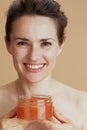 smiling modern woman with face scrub