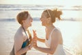 Smiling modern mother and child at beach having fun time Royalty Free Stock Photo