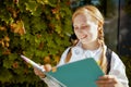 Smiling modern pupil in white sweatshirt outdoors in city