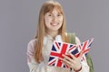 smiling modern teenager girl in beige tracksuit with backpack