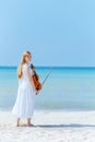 smiling modern teenager girl in white dress on ocean coast Royalty Free Stock Photo