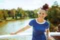 Smiling modern tourist woman on river boat having river voyage