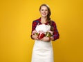 Smiling modern woman farmer with jars of marinated vegetables