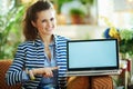 Smiling modern woman and pointing at laptop blank screen Royalty Free Stock Photo