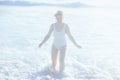 smiling modern woman in white swimwear at beach having fun time Royalty Free Stock Photo