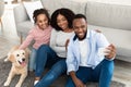 Young black family taking selfie with pet at home Royalty Free Stock Photo