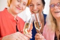 Smiling Mom Friends Tossing Glasses of Champagne