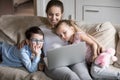 Smiling mom relaxing with kids on sofa watching cartoons Royalty Free Stock Photo