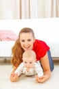 Smiling mommy and adorable baby playing on floor Royalty Free Stock Photo