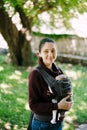 Smiling mother with baby in a sling. Close-up Royalty Free Stock Photo