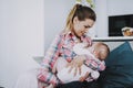 Smiling Mother Breast Feeding Little Baby Indoors