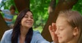 Smiling mother caress daughter on picnic close up. Children have fun with mum.