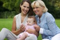 Smiling mother with child and grandmother outdoors Royalty Free Stock Photo