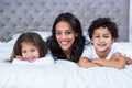 Smiling mother with children on the bed Royalty Free Stock Photo