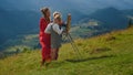 Happy family drawing mountains outdoor. Painter and kids creating picture. Royalty Free Stock Photo