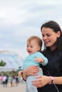 smiling mother with cute baby in her arms outdoors Royalty Free Stock Photo