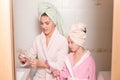 Smiling mother and daughter brushing their teeth. Royalty Free Stock Photo