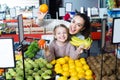 Smiling mother and daughter buying fruits Royalty Free Stock Photo