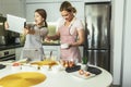 Mother and daughter cooking together in the kitchen, having fun, make photo Royalty Free Stock Photo