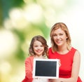 Smiling mother and daughter with tablet pc