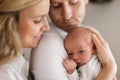 Smiling mother and father holding their newborn baby daughter at home Royalty Free Stock Photo