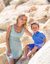 Smiling mother and her little son. Yellow rocks and stones. Concept of mothers Day. Family outdoors portrait. Royalty Free Stock Photo