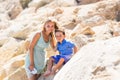 Smiling mother and her little son. Yellow rocks and stones. Concept of mothers Day. Family outdoors portrait. Royalty Free Stock Photo