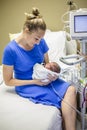 Smiling Mother holding her newborn premature baby in the hospital Royalty Free Stock Photo