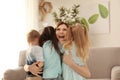 Smiling mother hugging her cute little children at home Royalty Free Stock Photo