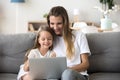 Smiling mother and kid having fun shopping online with laptop Royalty Free Stock Photo