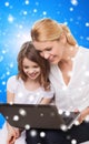 Smiling mother and little girl with laptop Royalty Free Stock Photo