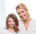 Smiling mother and little girl with laptop at home Royalty Free Stock Photo