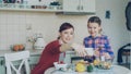 Smiling mother making selfie photo together with young cute daughter cooking breakfast at home in kitchen. Family, cook Royalty Free Stock Photo