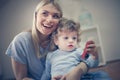 Smiling mother play with her baby boy. Royalty Free Stock Photo