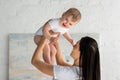 smiling mother playing with cute happy baby in hands Royalty Free Stock Photo