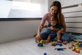 Smiling mother playing with her cute toddler son at home Royalty Free Stock Photo