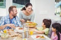 Smiling mother serving food to children Royalty Free Stock Photo