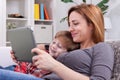 Smiling mother and son using tablet