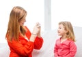 Smiling mother taking picture of daughter Royalty Free Stock Photo