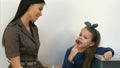 Smiling mother talking to her little girl eating a lollipop at doctor`s office Royalty Free Stock Photo