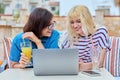Smiling mother and teenage daughter looking into laptop screen together Royalty Free Stock Photo
