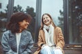 Smiling multi-ethnic best female friends spending time together on fresh air in autumn time Royalty Free Stock Photo