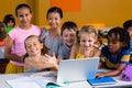 Smiling multi ethnic children using laptop