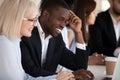 Smiling multi-ethnic coworkers working together in office using Royalty Free Stock Photo