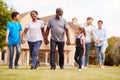 Smiling Multi-Generation Mixed Race Family Walking In Garden At Home Royalty Free Stock Photo