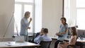 Smiling multi racial teammates attend briefing in coworking office Royalty Free Stock Photo