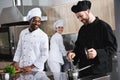smiling multicultural chefs cooking together