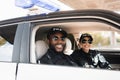 Smiling multicultural police officers looking at